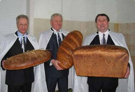 3 guys holding 3 oversized bread